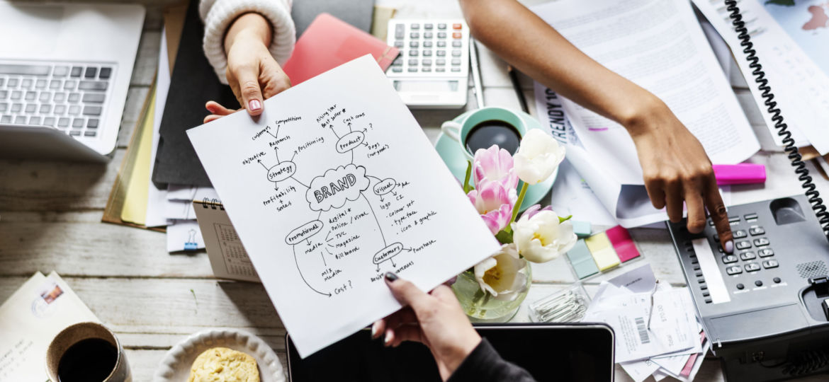 Colleagues Handing Branding Plan Strategy to other